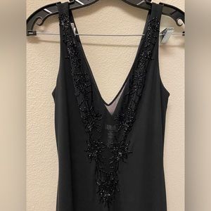 Laundry mid length black dress with neck line beading.